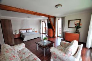 a living room with a bed and a couch at Pensjonat Relax in Mikołajki +34 photos