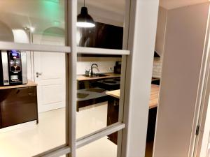 a kitchen with white cabinets and a refrigerator at Pensiunea La Brazi in Mănăstirea Humorului