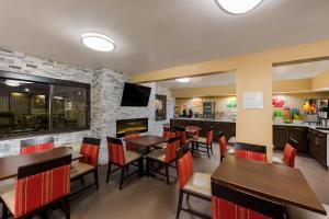 a restaurant with tables and chairs and a fireplace at Quality Inn in Marysville