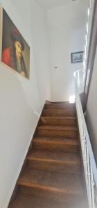 a staircase with a painting of a man on the wall at S.Soares Beato 6.2D in Lisbon