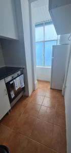 a kitchen with a tile floor and a window at S.Soares Beato 6.2D in Lisbon