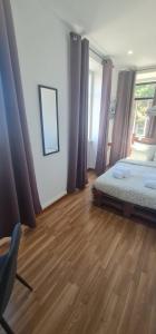 a bedroom with a bed and a wooden floor at S.Soares Beato 6.2D in Lisbon