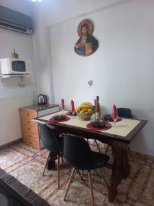 a kitchen with a table with a bowl of fruit on it at HARMA cozy apartment in Athens