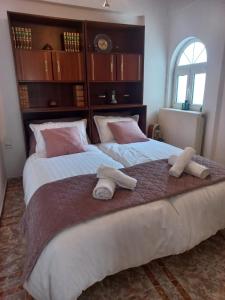 une chambre avec deux lits avec des serviettes dessus dans l'établissement HARMA cozy apartment, à Athènes
