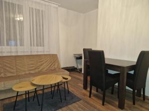 a living room with a couch and a table and chairs at Extra studio apartment Sarajevo in Sarajevo