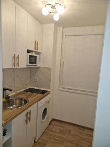 a small kitchen with a sink and a microwave at Extra studio apartment Sarajevo in Sarajevo