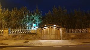 a driveway with a wooden garage door with lights on it at Pensión ** Abacá Gijón in Gijón