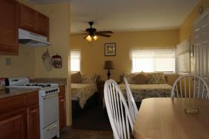 a kitchen and living room with a table and a couch at Lake Place Resort in Glenhaven