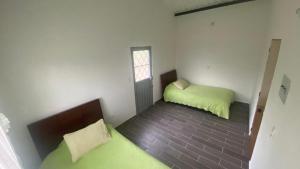 a small room with two beds and a window at CABAÑA LA MONTAÑA in San Antonio del Tequendama