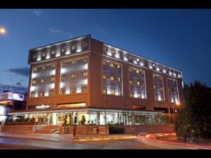 a large brick building with lights in front of it at Euro Park Otel in Istanbul