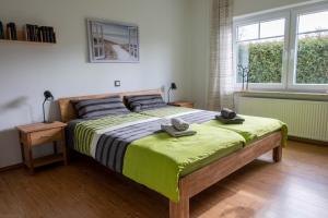 a bedroom with a large bed with two hats on it at FH Ostfriesland to Huus, zw. Emden und Greetsiel in Hinte