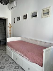 um quarto com uma cama com um colchão vermelho em Traditional Myconian Studio in the heart of Chora em Míconos