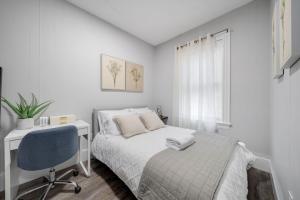 a bedroom with a bed and a desk and a chair at 4BR 1BH Apt in South Boston near Old Harbor Beach in Boston