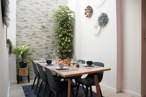 a dining room with a table with chairs and plants at Guesthouse do Sol - Luxury Villa in Tomar