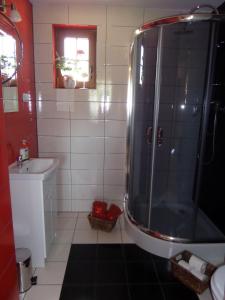 La salle de bains est pourvue d'une douche et d'un lavabo. dans l'établissement Domek 12 osobowy na Kaszubach - Agrowczasy U PIANKA, 