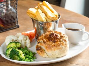 a plate of food with bread and vegetables and a cup of coffee at Parkside Hotel in Cleator