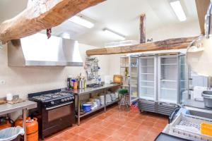 a kitchen with a stove top oven in a kitchen at CASA RURAL, con Jacuzzi, Chimenea, BBQ, Bar y mucho mas in Almazán