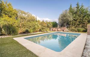 a swimming pool in a yard with trees at 2 Bedroom Amazing Home In Viuela in Viñuela