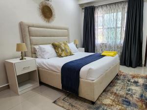 a bedroom with a large bed and a window at InstaHomes by Tru - Villa in Blantyre