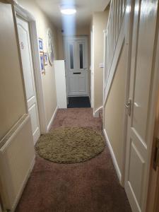 a hallway with a carpet and a door with a rug at NHYL HOMES in Wibsey
