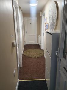 a hallway with a door and a rug in a room at NHYL HOMES in Wibsey