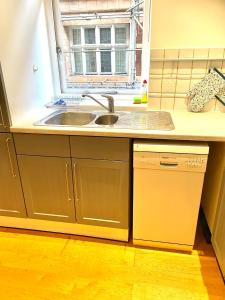 a kitchen with a sink and a window at Sight Flats - SF02 - One Bedroom in London