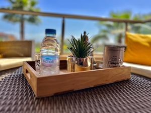 a wooden tray with a bottle of water on a table at Marrakech golf City prestigia in Marrakesh