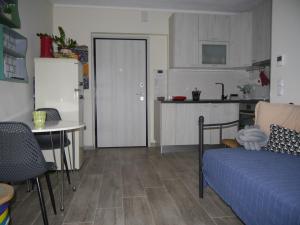 a living room with a couch and a table and a kitchen at Cozy & Stylish Eastside Apt. in Thessaloniki