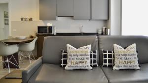 a couch with two pillows on it in a kitchen at RivApartmentsDowntowN Travel in Riva del Garda