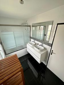 a bathroom with two sinks and a mirror at NatySweethome in Magny-le-Hongre