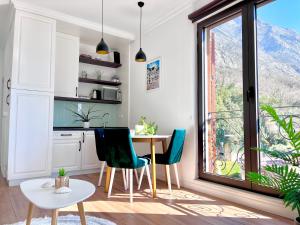 a kitchen with a table and chairs and a window at Vacanza, Sea view in Kotor