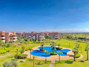 an aerial view of a park with palm trees at Marrakech golf City prestigia in Marrakesh