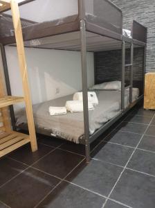 a couple of bunk beds in a room at Casas de praia Sandra e Nelson in Almada