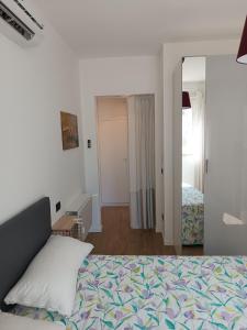 a bedroom with a bed and a mirror at Appartamento per 4, Metro B Monti Tiburtini, AC, Wi-Fi in Rome