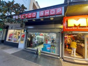 a store front with a woman walking in front of it at Apartment Podgorica centre in Podgorica