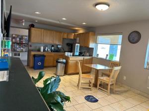 a kitchen with a table and chairs and a counter at Super 8 by Wyndham Greeley in Greeley