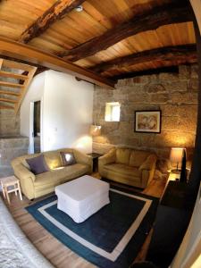a living room with a couch and a table at Vila Cavalica in Bustelo +23 photos