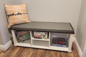 a bench with a pillow and books on it at Molino in Las Vegas