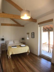a bedroom with a bed and a large window at Vila Forno in Bustelo +34 photos