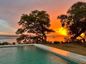 a swimming pool with a sunset in the background at Waterway in Charleston