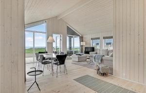 a living room with a table and chairs and a couch at 3 Bedroom Beach Front Home In Kalundborg in Kalundborg