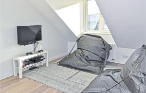 a living room with a chair and a tv at Nautilus 1 in Bergen aan Zee