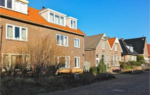 a row of brick houses with an orange roof at Nautilus 1 in Bergen aan Zee