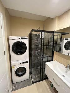a laundry room with a washer and dryer next to a sink at Luxe Residance in International financial Center, close to watergarden mall in Istanbul