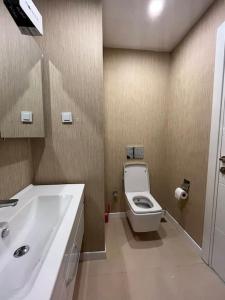 a bathroom with a white toilet and a sink at Luxe Residance in International financial Center, close to watergarden mall in Istanbul