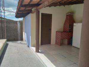 an outside view of a house with a brick fireplace at Casa Vila Cintra in Pirenópolis