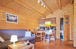 a living room with a couch and a table in a cabin at Nice Home In Sianozety With Kitchen in Sianozety