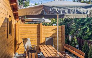 a patio with an umbrella and a table and chairs at Nice Home In Sianozety With Kitchen in Sianozety