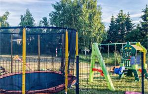 a playground with two play equipment in a park at Nice Home In Sianozety With Kitchen in Sianozety