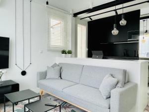a living room with a couch and a kitchen at Respiro Del Mar - Beachfront Superior Apartment in L'Ametlla de Mar